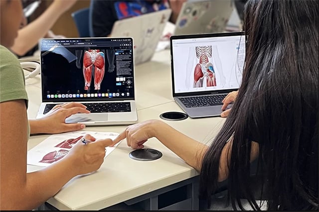 Students in a computer lab looking at Visible Body on laptops